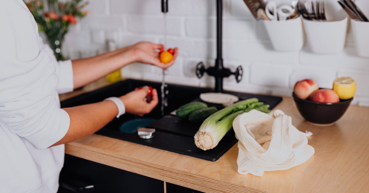 TAP Airline Refund - Woman Washing Fresh Ingredients under Tap Water in Kitchen TAP Airline Refund - Woman Washing Fresh Ingredients under Tap Water in Kitchen