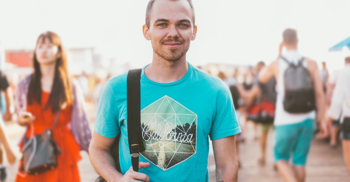 Tattoos while Traveling Overseas - Man Holding Black Bag Tattoos while Traveling Overseas - Man Holding Black Bag
