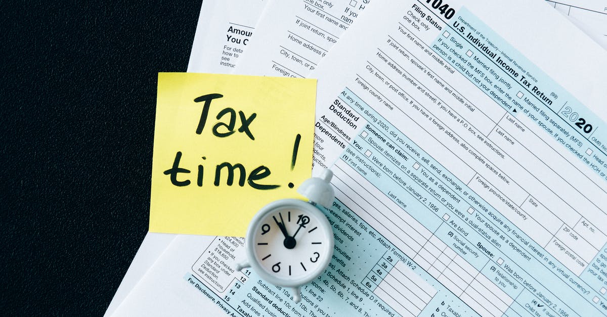 Tax refund flying out of California? - Tax Documents on Black Table