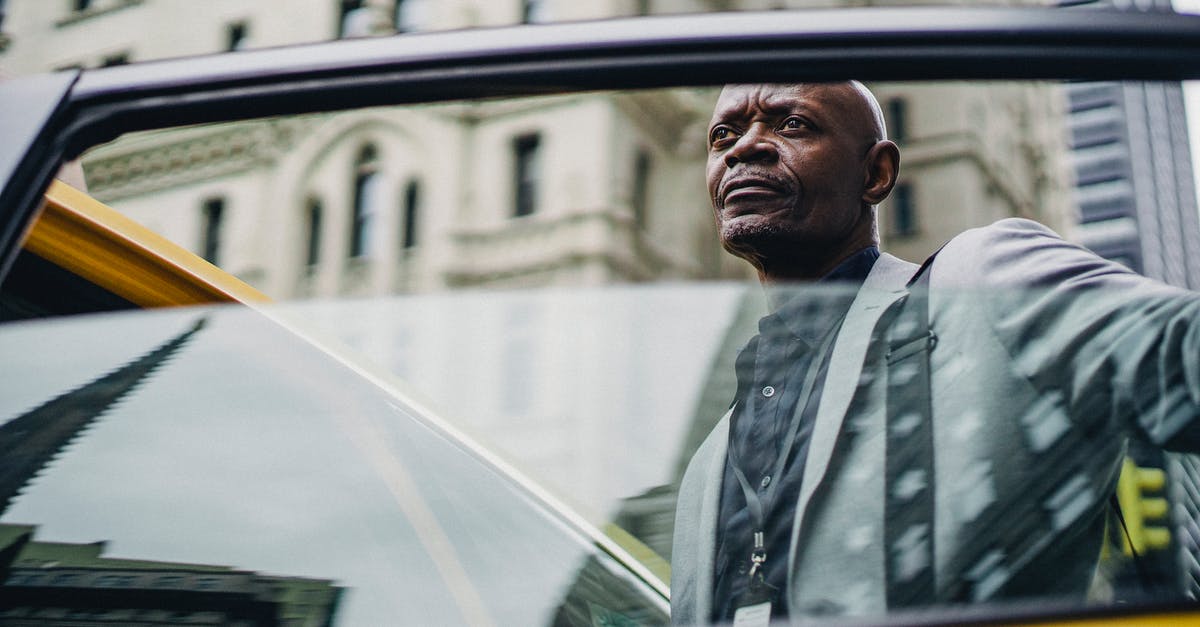 Taxi ride from Lima airport to Miraflores - Pondering black man opening taxi door Taxi ride from Lima airport to Miraflores - Pondering black man opening taxi door