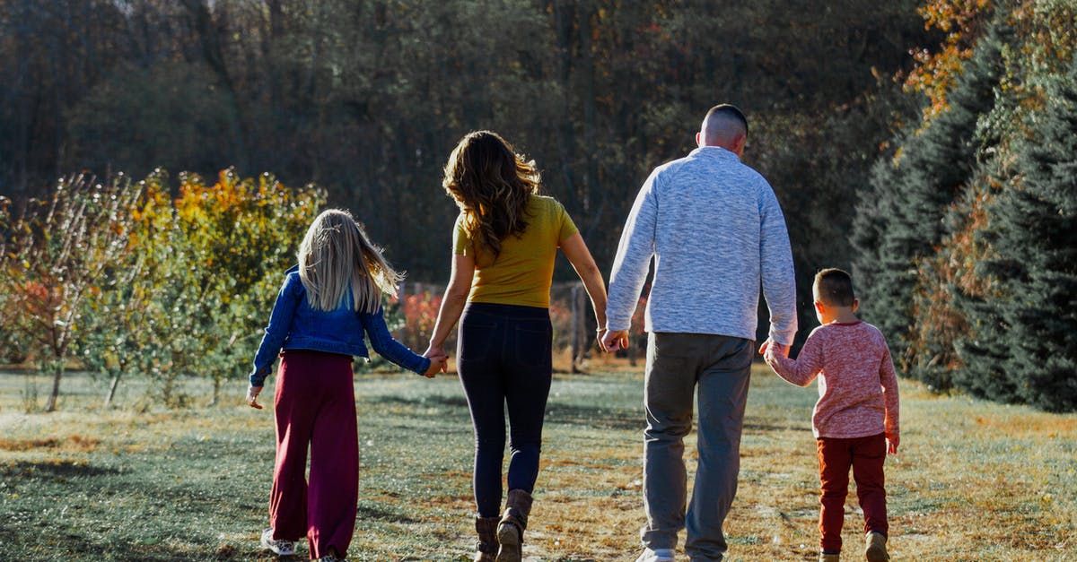 Teen child traveling with family member within US - Happy family walking in countryside Teen child traveling with family member within US - Happy family walking in countryside
