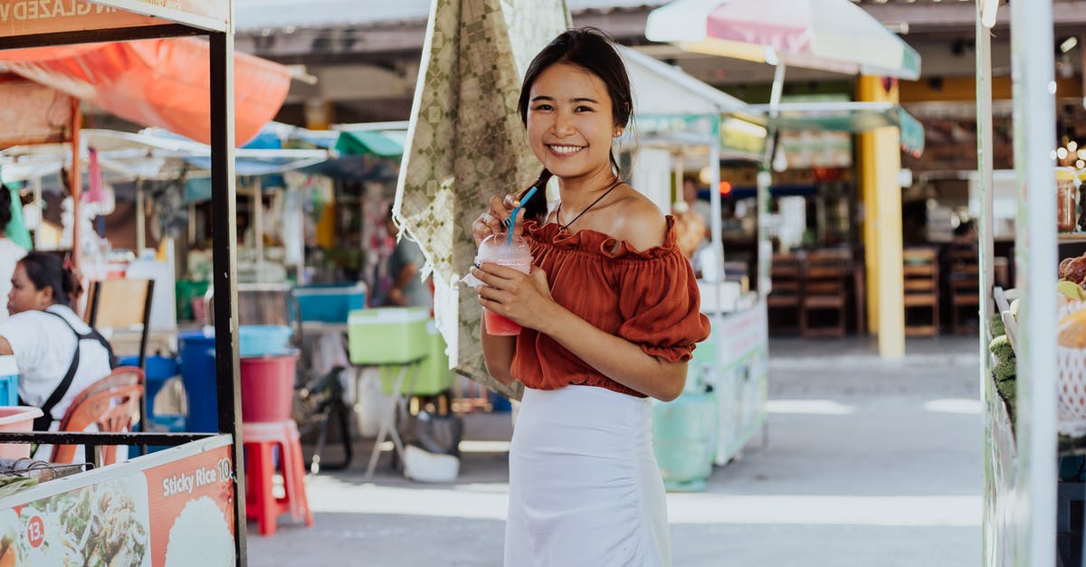 Thai Tourist Visa and Exemption - Woman in Brown Long Sleeve Shirt and White Skirt Holding Umbrella Thai Tourist Visa and Exemption - Woman in Brown Long Sleeve Shirt and White Skirt Holding Umbrella