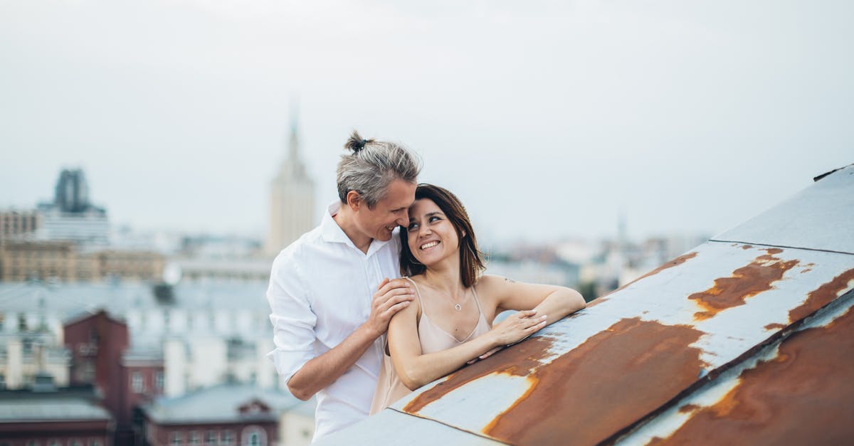 The most pleasant cities to stay in Ireland, other than Dublin? [closed] - Smiling couple hugging on city roof