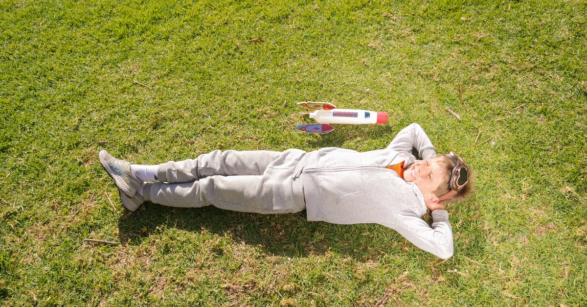 Things to do with young children in Paris in August - Man in Gray Pants Lying on Green Grass Field Things to do with young children in Paris in August - Man in Gray Pants Lying on Green Grass Field