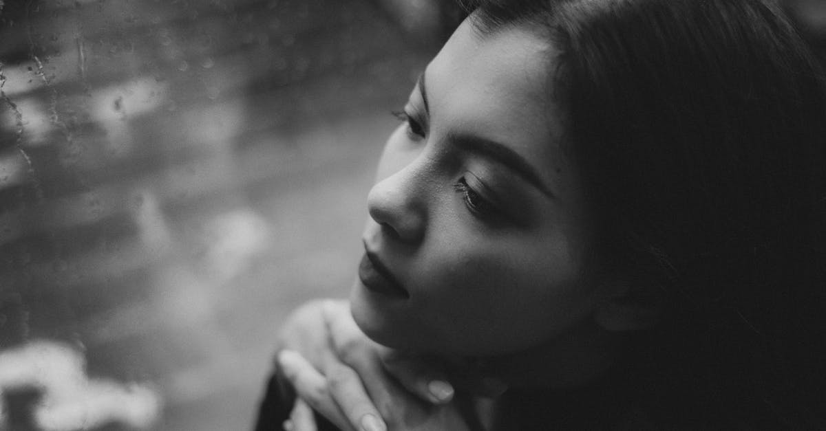 Things to keep in mind when going to the Amazon rain forest - Black and white high angle of serious teenage girl sitting in solitude near window covered with raindrops Things to keep in mind when going to the Amazon rain forest - Black and white high angle of serious teenage girl sitting in solitude near window covered with raindrops