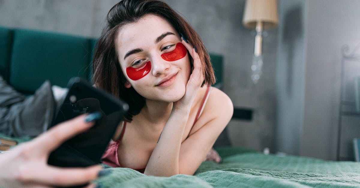 Tier 5 (Youth Mobility Visa) - Age [closed] - A Woman with an Under Eye Patches Taking a Selfie While Lying on the Bed