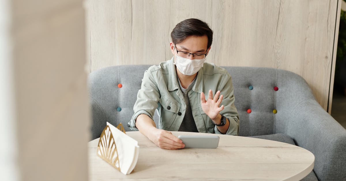 Tight international connection at Atlanta? - Man Wearing A Face Mask Having A Video Call Tight international connection at Atlanta? - Man Wearing A Face Mask Having A Video Call