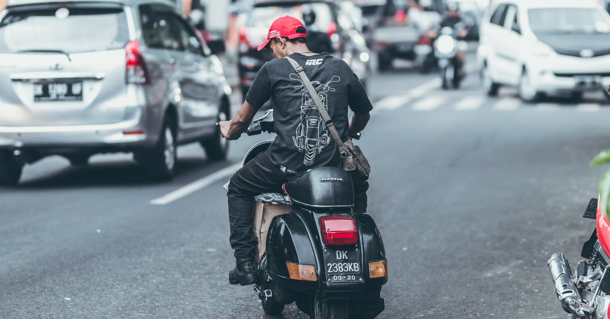 Time needed to get a Vietnamese motorcycle license and riding into Laos and Cambodia? [closed] - Photo of Man Riding Motorcycle on the Road