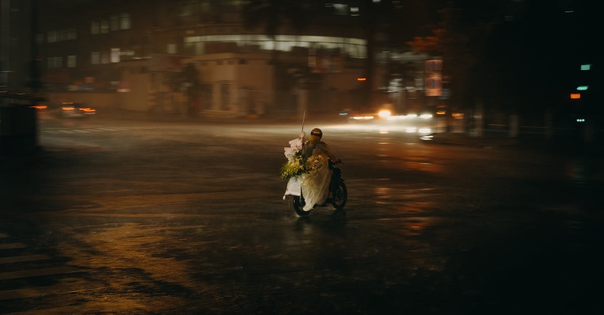 Time needed to get a Vietnamese motorcycle license and riding into Laos and Cambodia? [closed] - A Person Riding a Motorcycle During Rainy Night