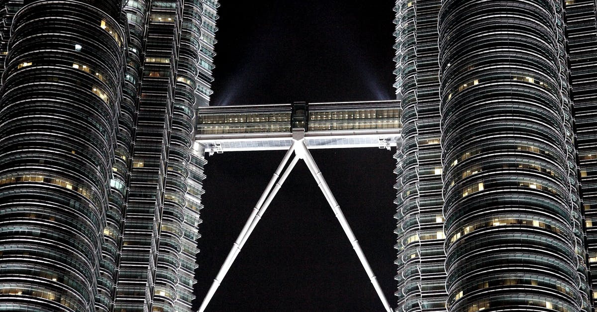Time to get to KUL from center of Kuala Lumpur - Twin high rise towers at night Time to get to KUL from center of Kuala Lumpur - Twin high rise towers at night