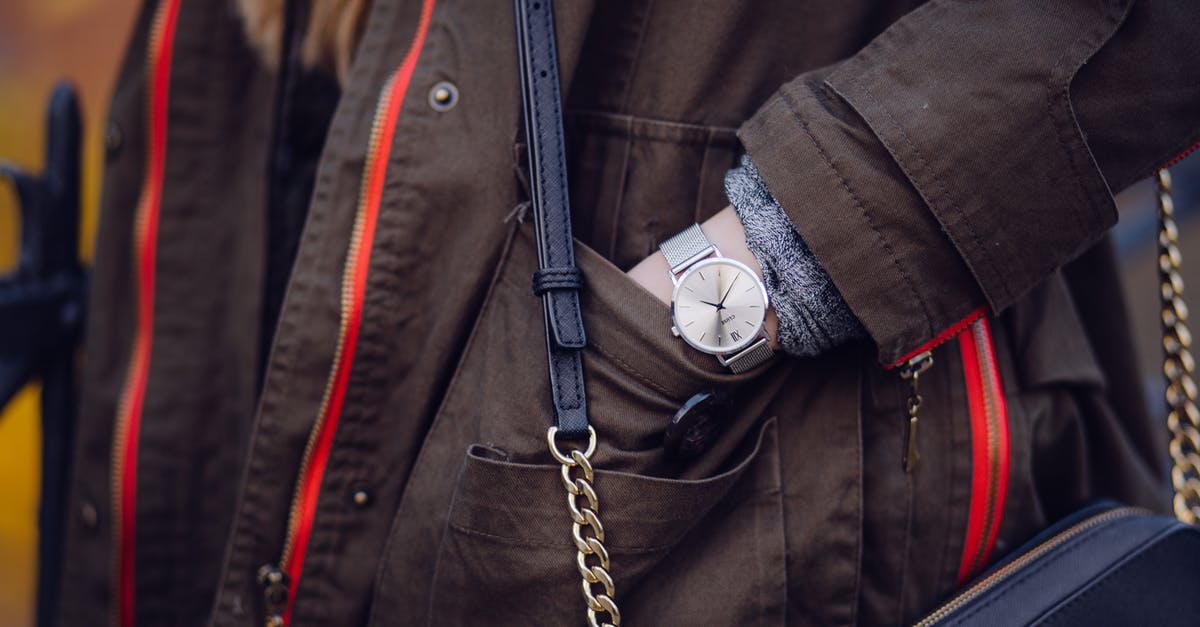 Time to Recheck Bag? - Woman Brown Coat Wearing Silver Analog Watch While Hand in Her Pocket Time to Recheck Bag? - Woman Brown Coat Wearing Silver Analog Watch While Hand in Her Pocket