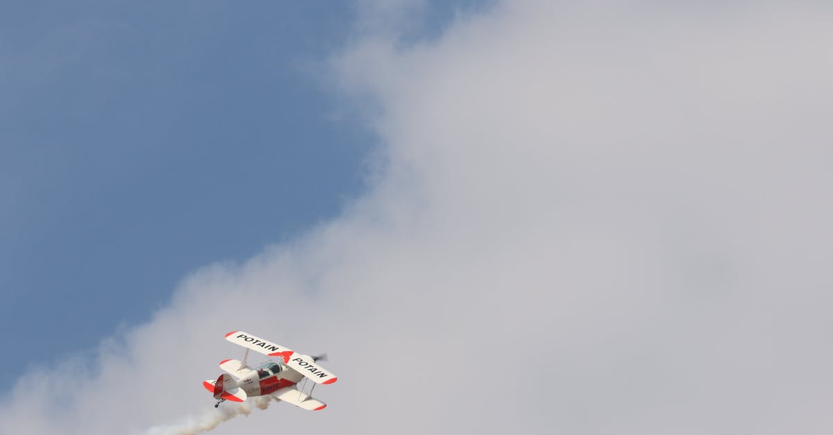 Tips and tricks surviving a long-haul flight departing at midnight - White and Red Biplane Flying during White Cloudy Day Tips and tricks surviving a long-haul flight departing at midnight - White and Red Biplane Flying during White Cloudy Day