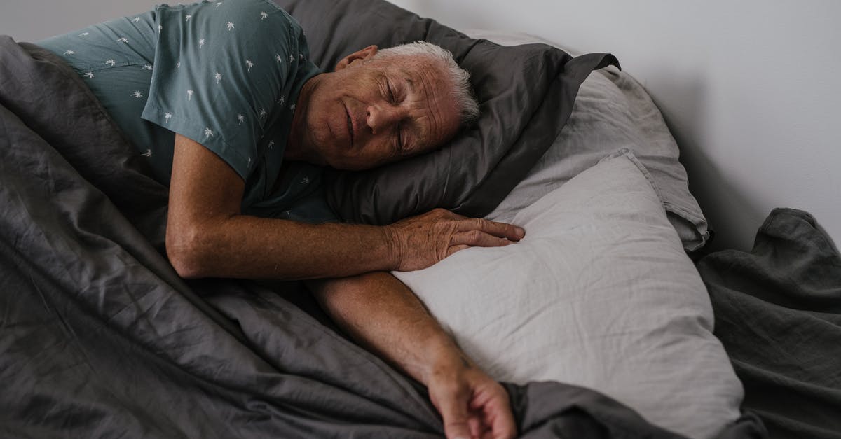 Tips for sleeping in a Couchette sleeping carriage? - Man in Grey T-shirt Lying on Bed Tips for sleeping in a Couchette sleeping carriage? - Man in Grey T-shirt Lying on Bed