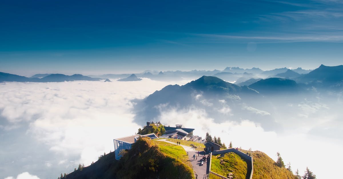 Toilet and half-bath in huts in Switzerland Alps - Birds Eye View of House on Hill over White Clouds