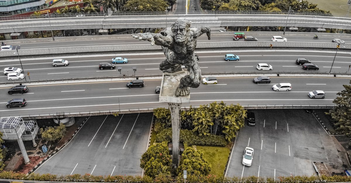 Toll gate misreads toll transponder in rental car - Aerial view of Dirgantara statue also known as Tugu Pancoran Monument is an iconic Indonesa National Monument Toll gate misreads toll transponder in rental car - Aerial view of Dirgantara statue also known as Tugu Pancoran Monument is an iconic Indonesa National Monument