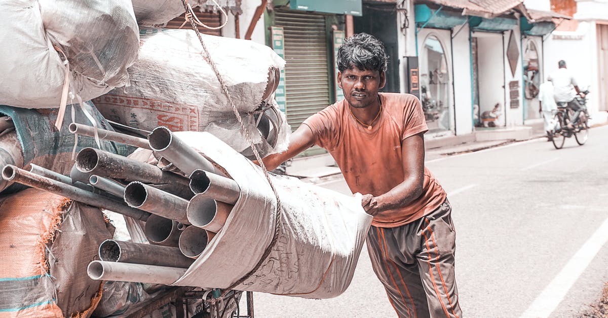 Too many countries to apply for Indian E-Visa? - Man Holding White Sack Filled With Pipes Too many countries to apply for Indian E-Visa? - Man Holding White Sack Filled With Pipes