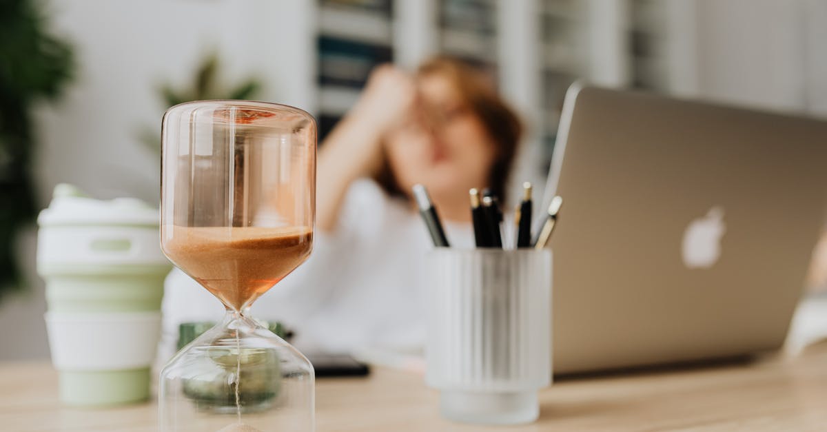 Too much time in the US? (using VWP) [duplicate] - Woman in Black Tank Top Sitting Beside Table With Clear Glass Hour Glass