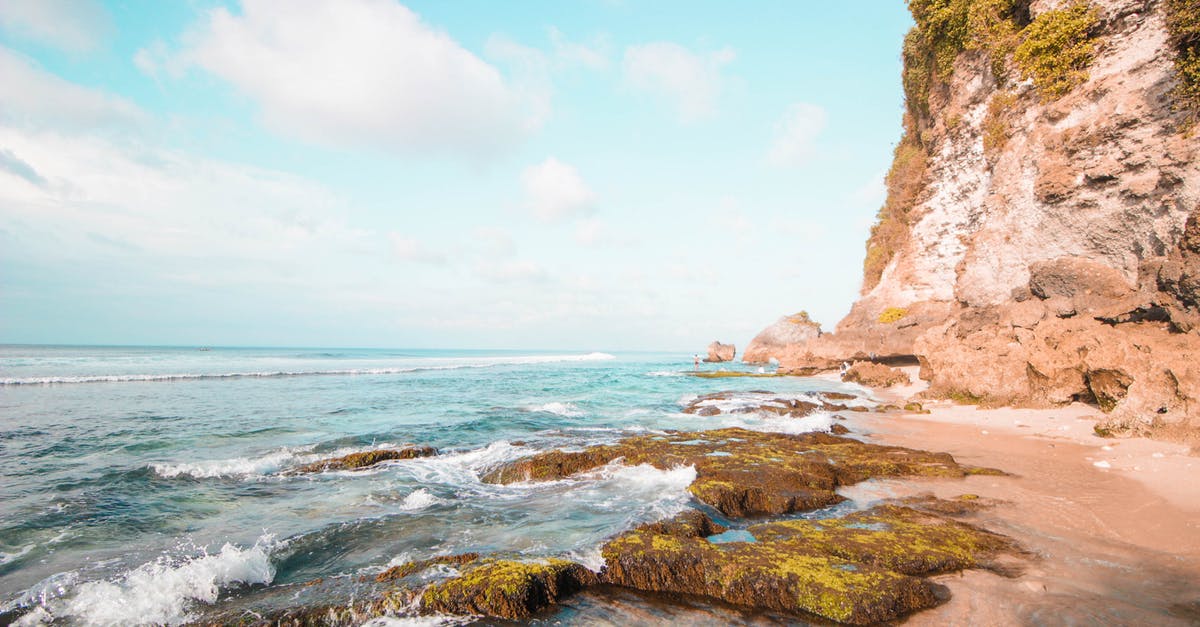 Toronto Airport (YYZ) to Sanur Bali Indonesia - Brown Rock Formation Near Sea Toronto Airport (YYZ) to Sanur Bali Indonesia - Brown Rock Formation Near Sea