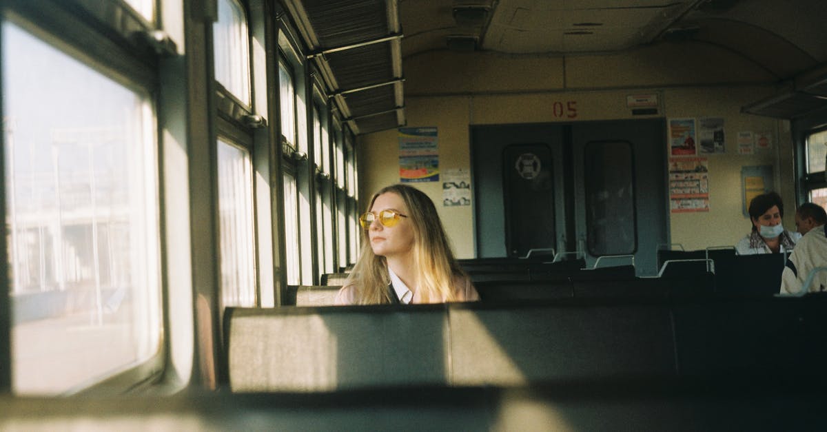 Train + rental car as alternative to air travel inside Europe - Pensive woman looking at window of train Train + rental car as alternative to air travel inside Europe - Pensive woman looking at window of train