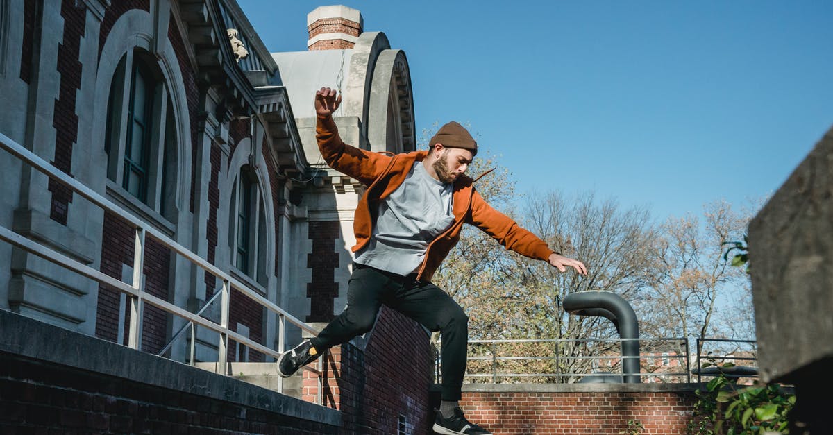 Train from Nice to Moscow / Border Controls - Energetic man jumping from wall in town Train from Nice to Moscow / Border Controls - Energetic man jumping from wall in town