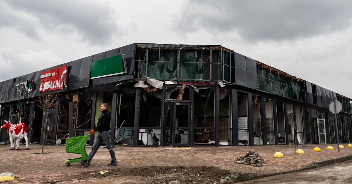 Train travel in Russia between host cities during Football World Cup 2018 - Man with shopping cart near destroyed market in Makariv, Ukraine Train travel in Russia between host cities during Football World Cup 2018 - Man with shopping cart near destroyed market in Makariv, Ukraine