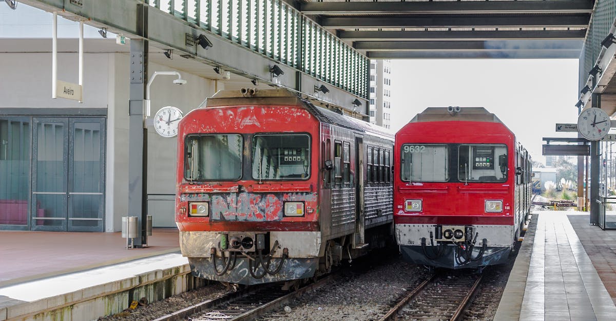 Trains from SFO to LA and vice-versa - Red and White Train in Train Station Trains from SFO to LA and vice-versa - Red and White Train in Train Station