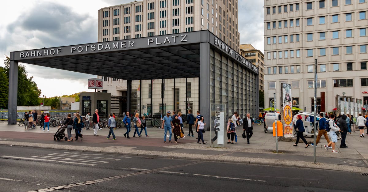 Transfer from Tegel Berlin to city center - People Walking on Sidewalk Near Building Transfer from Tegel Berlin to city center - People Walking on Sidewalk Near Building