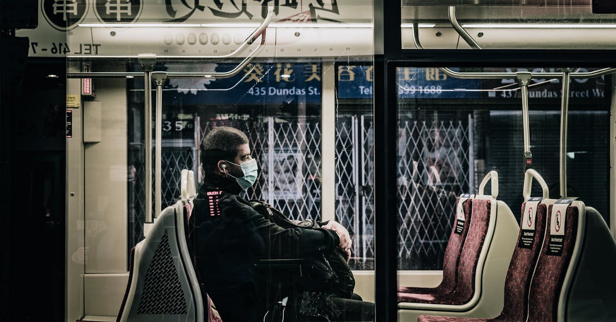 Transit through Netherlands AMS with a 9hr layover - Unrecognizable passenger in bus during COVID 19 pandemic Transit through Netherlands AMS with a 9hr layover - Unrecognizable passenger in bus during COVID 19 pandemic