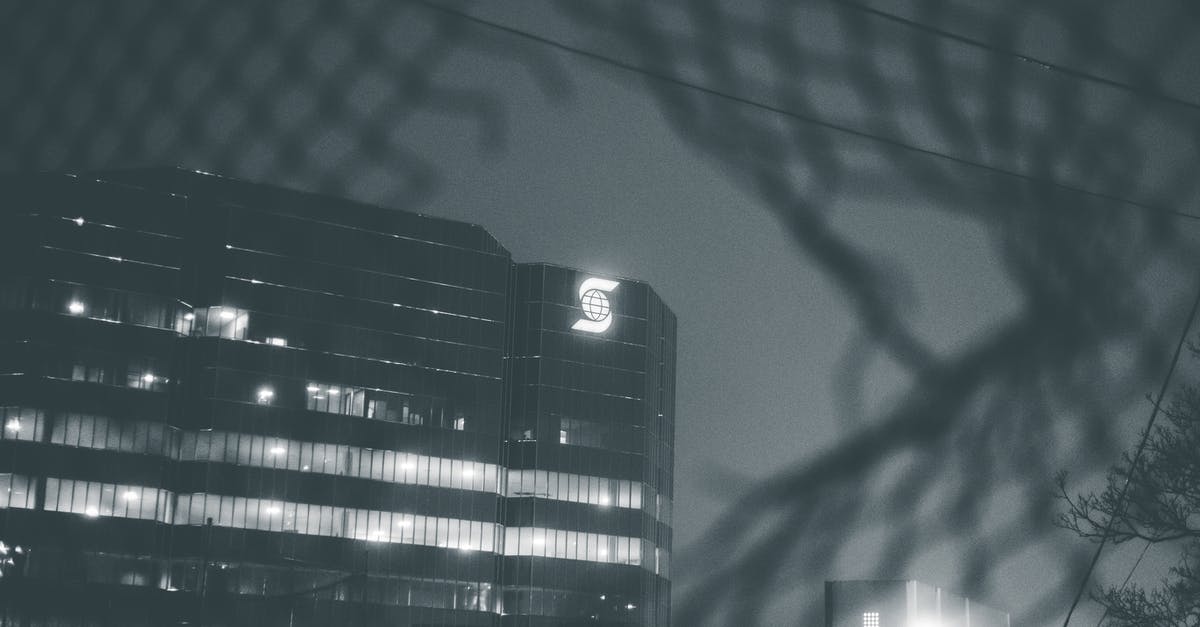 Transit through through the Schengen area with an EEA Family Permit - View through hole in metal fence on modern building in city