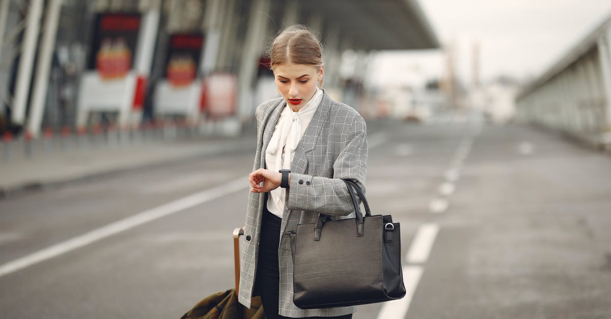 Transit Time in Frankfurt Airport - Short Connections - Worried young businesswoman with suitcase hurrying on flight on urban background
