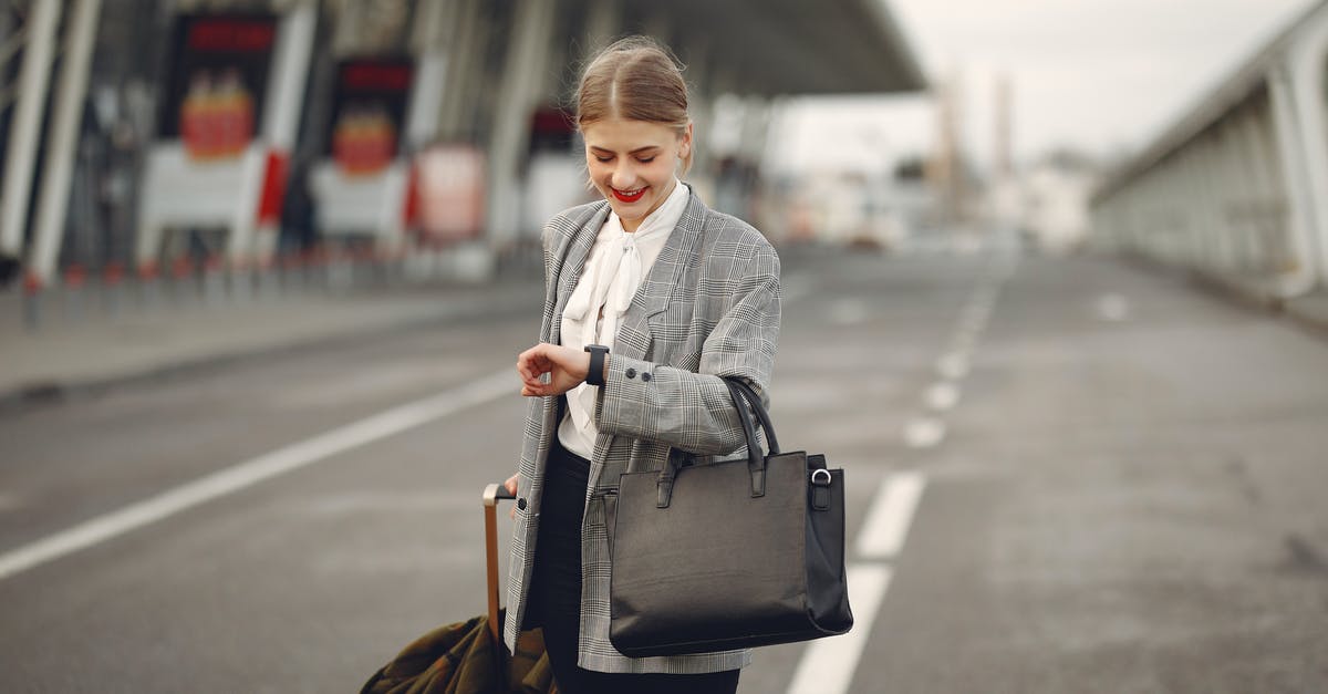 Transit Time in Frankfurt Airport - Short Connections - Positive young businesswoman with suitcase hurrying on flight on urban background