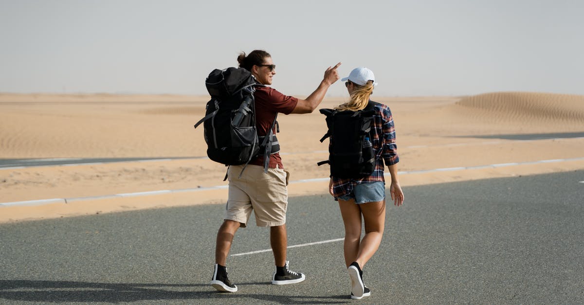 Transiting in Dubai on back-to-back return tickets - Man in Red Shirt Wearing Black Backpack Transiting in Dubai on back-to-back return tickets - Man in Red Shirt Wearing Black Backpack