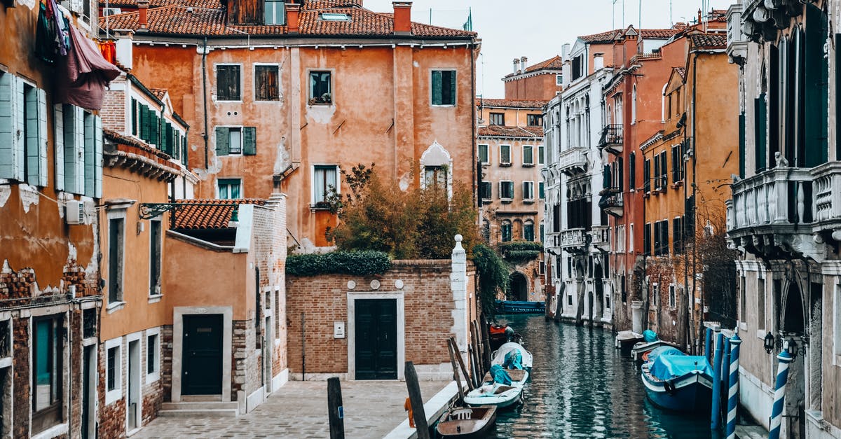 Transiting via Madrid to Venice - Street with Gondolas in City on Water Transiting via Madrid to Venice - Street with Gondolas in City on Water