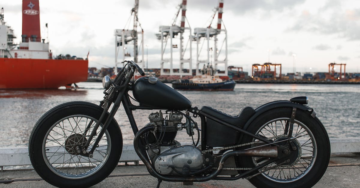 Transport Melbourne to Byron bay via Gold Coast Airport - Retro motorbike in river port against ships