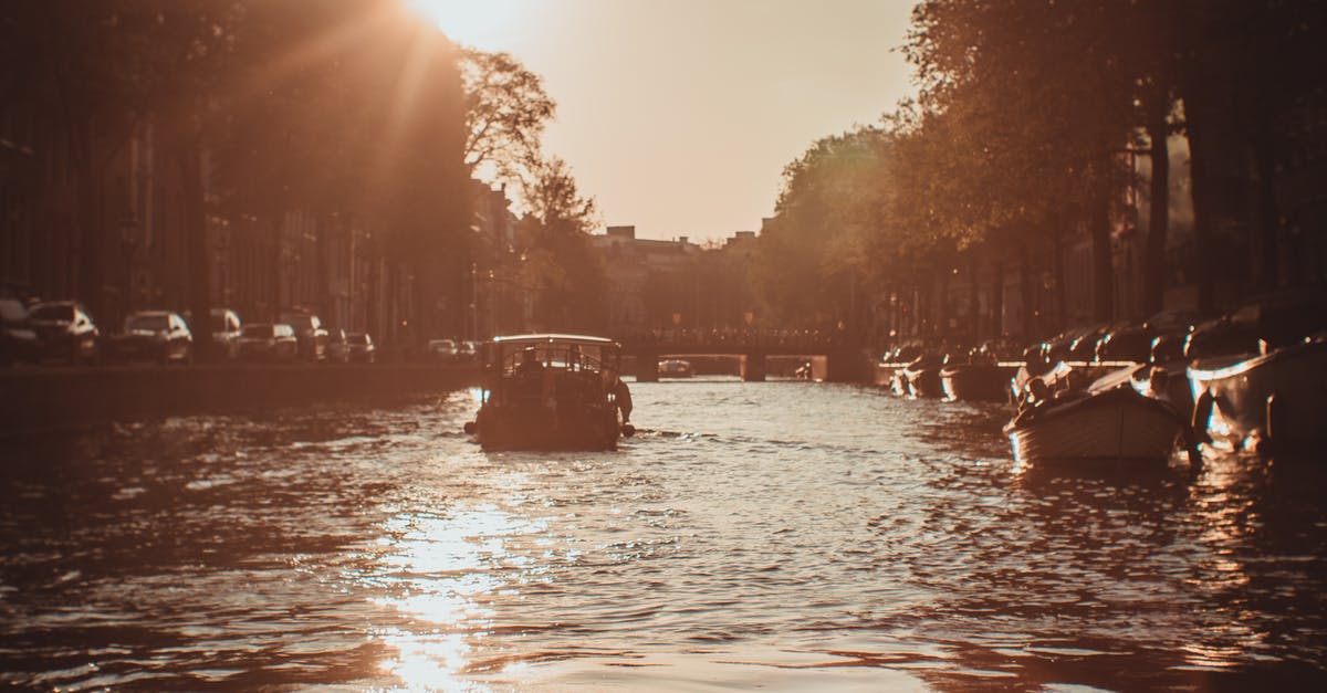 Transportation in Netherlands: to and around Amsterdam - Photo of Boat on River Transportation in Netherlands: to and around Amsterdam - Photo of Boat on River