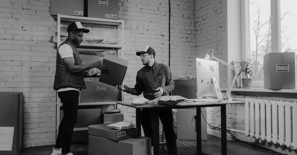 Transporting a big shipment of computer equipment to the Caribbean [closed] - Man in Black Jacket and Pants Standing Beside Table With Laptop Computer