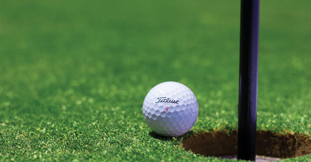 Transporting Golf club shafts - Titrist Golf Ball Near Golf Hole Transporting Golf club shafts - Titrist Golf Ball Near Golf Hole