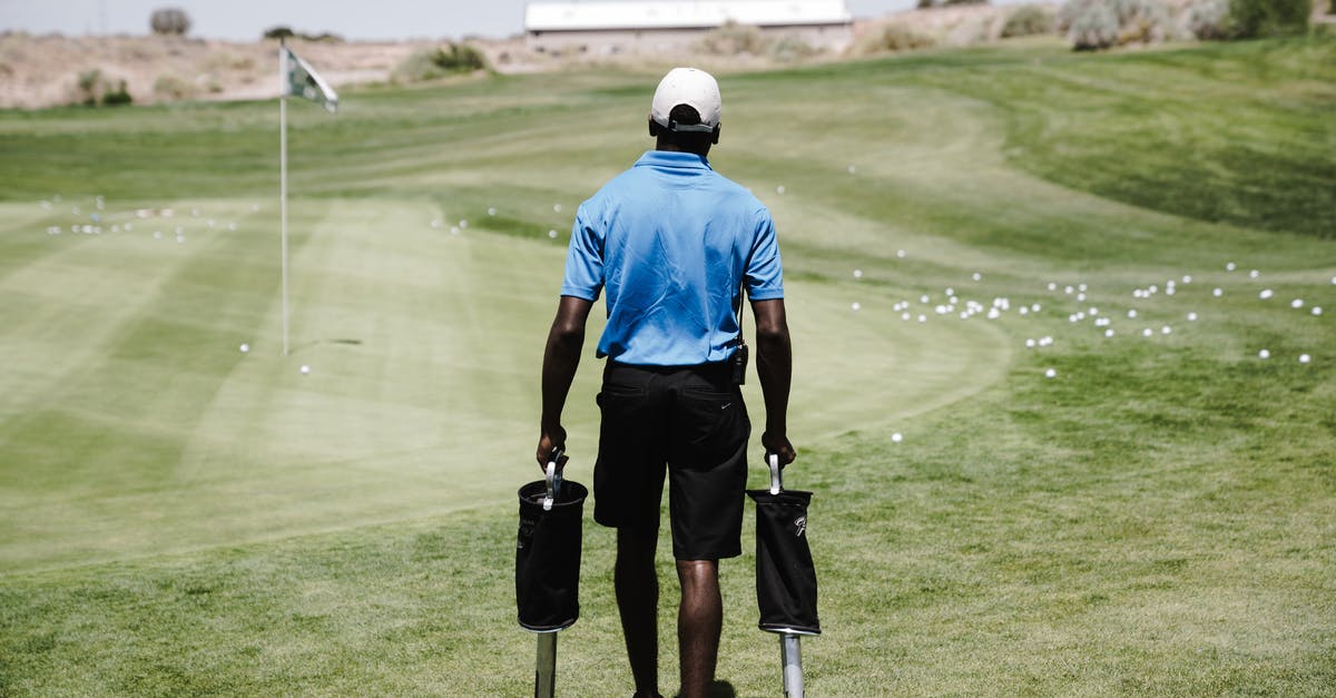 Transporting Golf club shafts - Man in Blue Polo Shirt Carrying Black Bags Transporting Golf club shafts - Man in Blue Polo Shirt Carrying Black Bags