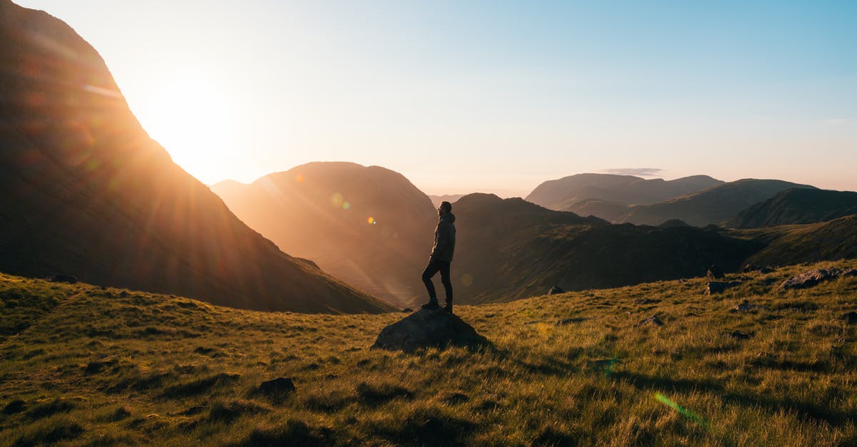 Travel alone on accompanied visa - Photo of Man Sitting on a Cave Travel alone on accompanied visa - Photo of Man Sitting on a Cave