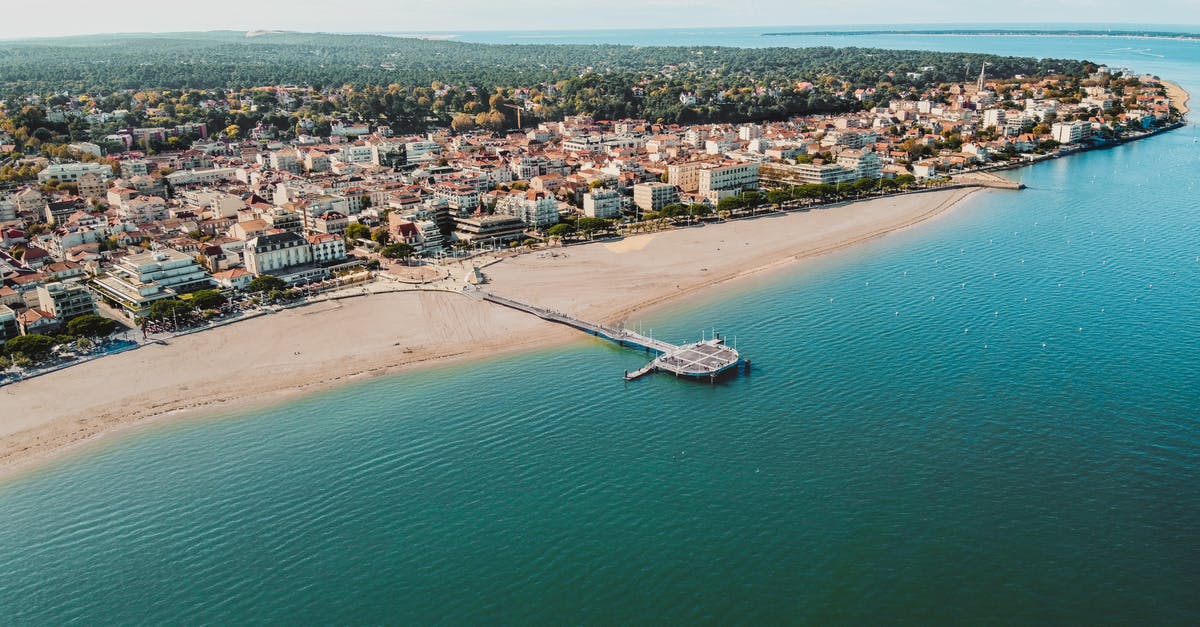 Travel back to France from Spain in order to complete French Residency - Aerial View of City Buildings Near Body of Water Travel back to France from Spain in order to complete French Residency - Aerial View of City Buildings Near Body of Water
