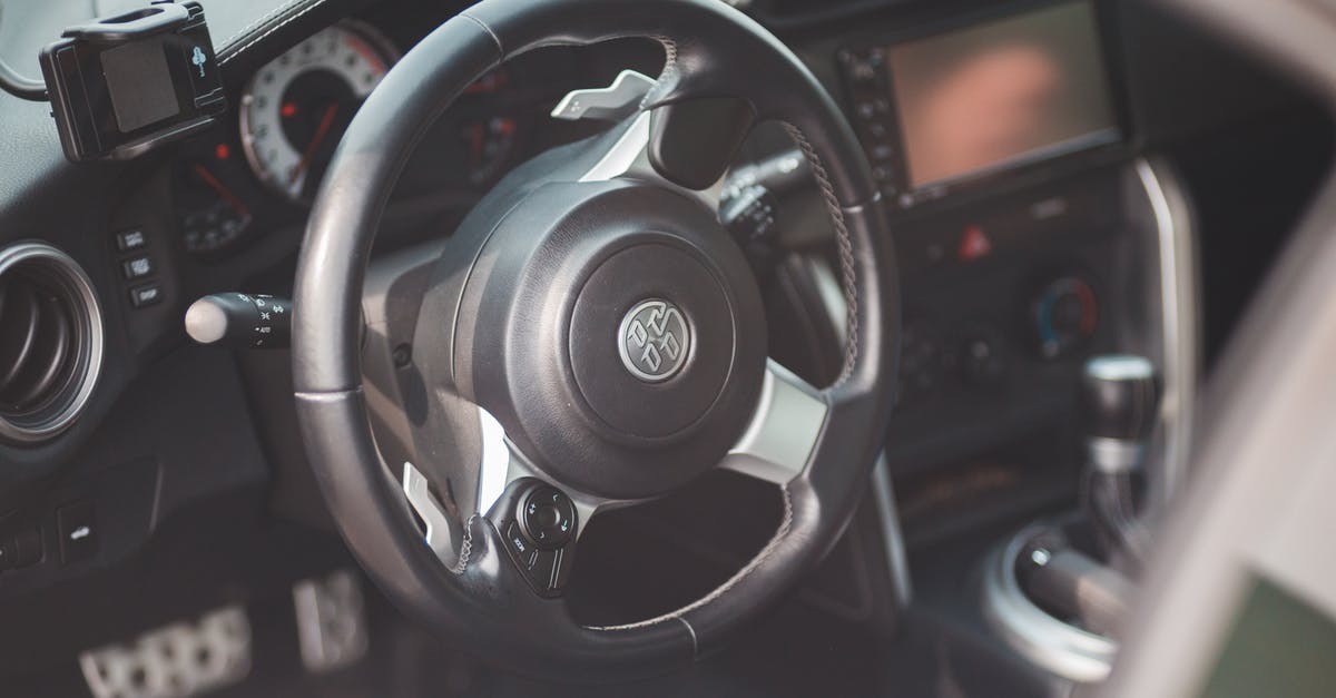 Travel from New Orleans to Dominican Republic via Miami - Steering wheel in modern fancy car Travel from New Orleans to Dominican Republic via Miami - Steering wheel in modern fancy car