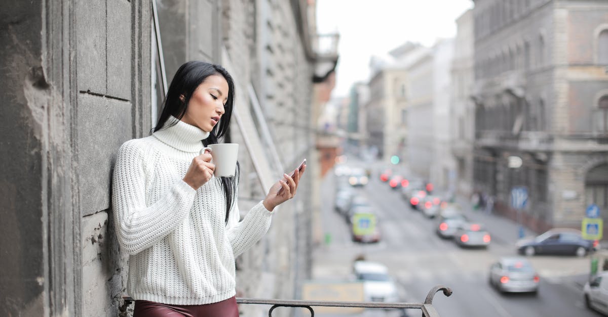 Travel Portable Battery - Woman in White Sweater Holding A White Ceramic Cup Travel Portable Battery - Woman in White Sweater Holding A White Ceramic Cup