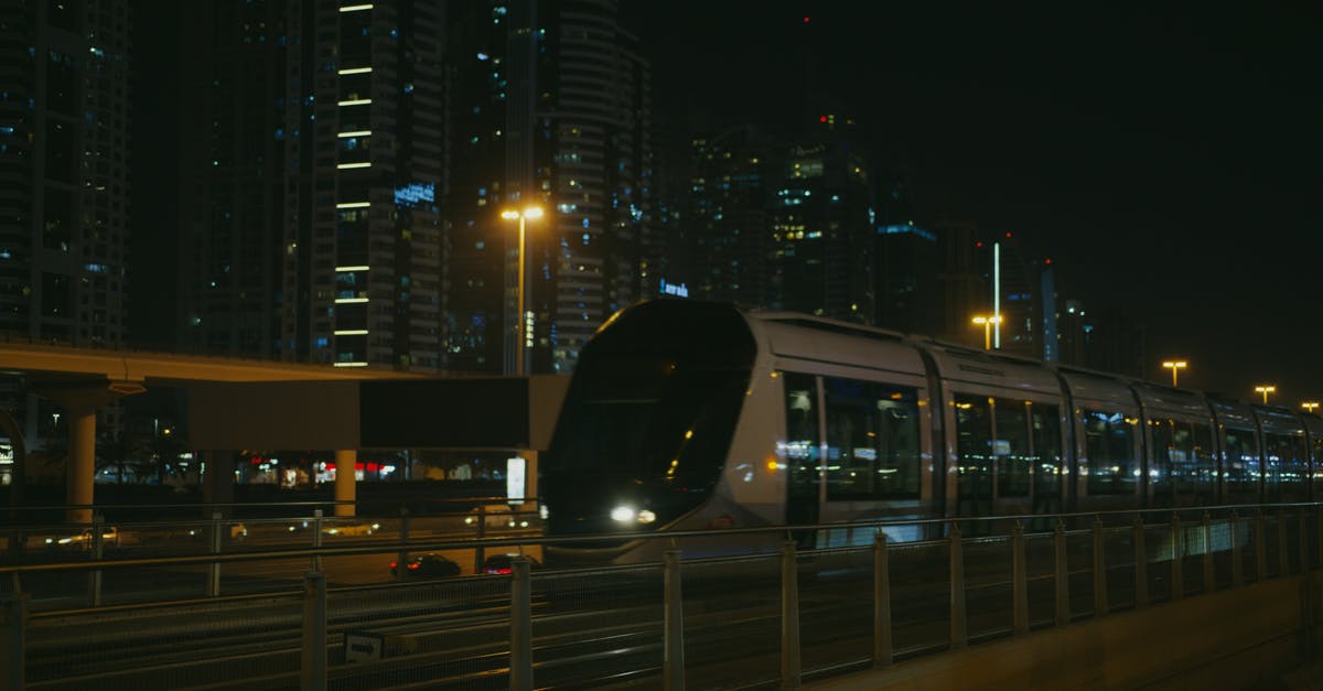 Travel to Oman from UAE by bus - White Train on Rail during Night Time Travel to Oman from UAE by bus - White Train on Rail during Night Time