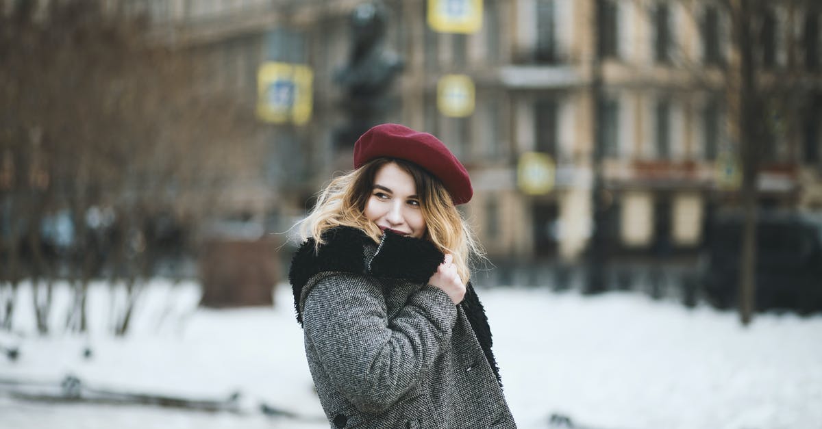 Travel within Schengen and Romania with French carte de séjour - Woman Wearing Coat and Red Hat during Snowy Day Travel within Schengen and Romania with French carte de séjour - Woman Wearing Coat and Red Hat during Snowy Day