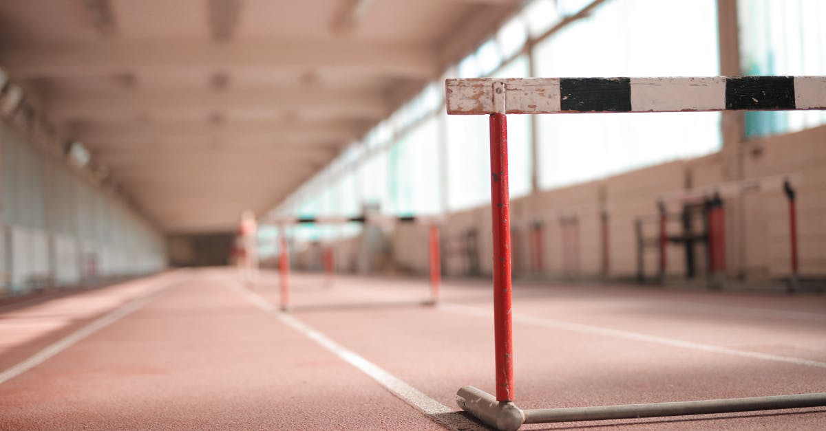 Travel within the Schengen area with Fiktionbescheinigung - Hurdle painted in white black and red colors placed on empty rubber running track in soft focus Travel within the Schengen area with Fiktionbescheinigung - Hurdle painted in white black and red colors placed on empty rubber running track in soft focus