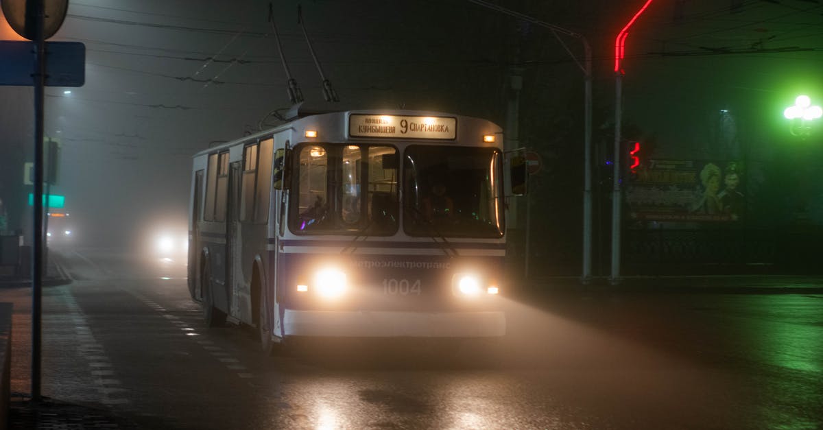 Travel within the Schengen area with Fiktionbescheinigung - Old trolleybus driving along wet asphalt road in small city at foggy night Travel within the Schengen area with Fiktionbescheinigung - Old trolleybus driving along wet asphalt road in small city at foggy night