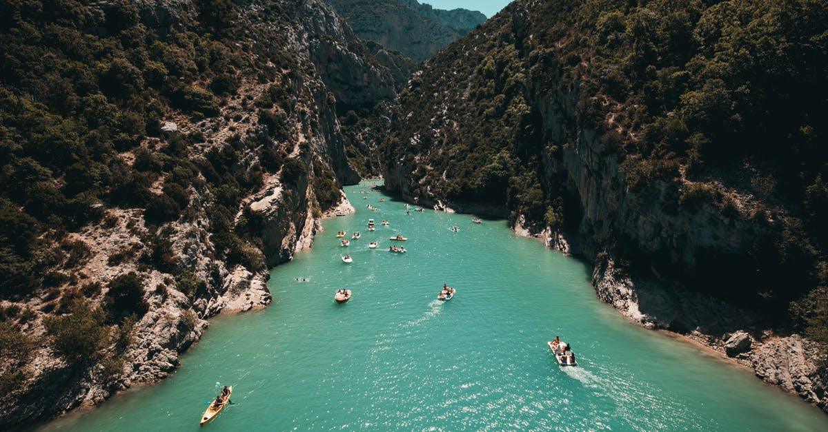 Traveling aboard an ocean liner like in The Royal Tenenbaums? - Photo of People Riding Kayaks Near Mountains Traveling aboard an ocean liner like in The Royal Tenenbaums? - Photo of People Riding Kayaks Near Mountains