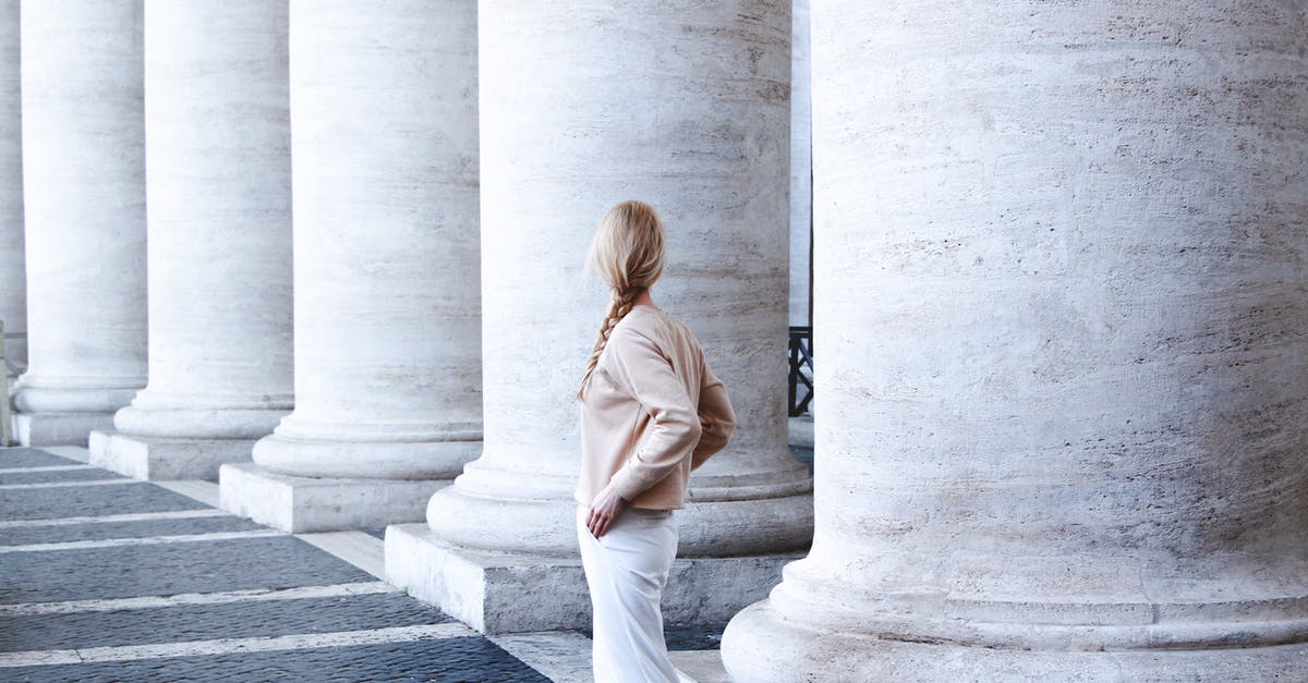 traveling and returning back to italy - Photo of Woman Standing Beside Concrete Pillar traveling and returning back to italy - Photo of Woman Standing Beside Concrete Pillar