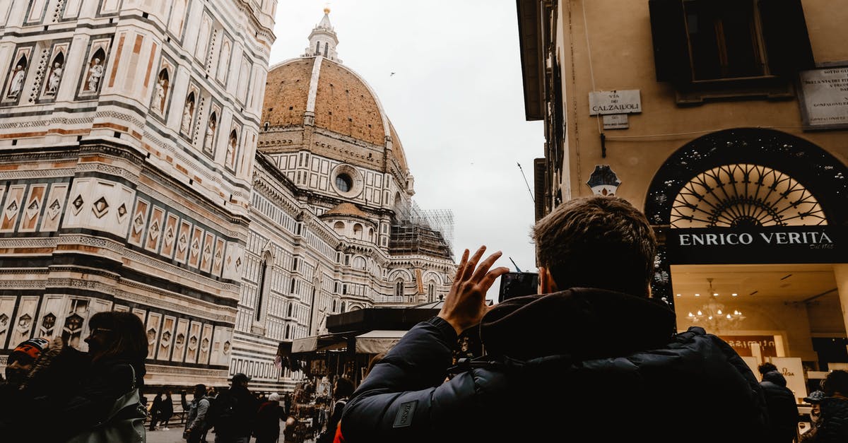 traveling and returning back to italy - A Man Taking Photo of the Building traveling and returning back to italy - A Man Taking Photo of the Building