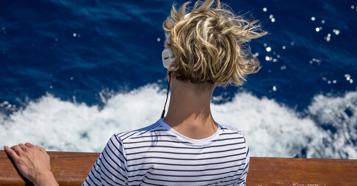 Traveling back from Bangladesh [closed] - Close-Up Photography of Man Looking Down the Sea